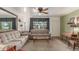 Comfortable living room featuring plush seating, ceiling fan, and ample natural light at 6905 Nelson St, Arvada, CO 80004