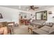 Spacious living room leading into a dining area with hardwood floors, perfect for gatherings at 6905 Nelson St, Arvada, CO 80004