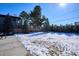 Snowy backyard with trees and seating area at 625 S Monroe Way, Denver, CO 80209