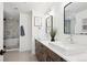 Modern bathroom with double sinks and a large shower at 625 S Monroe Way, Denver, CO 80209