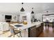 Modern kitchen with a large island, white cabinets and hardwood floors at 625 S Monroe Way, Denver, CO 80209