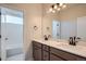 Bathroom showcasing a double sink vanity with modern fixtures and a shower and tub combo at 2690 E 102Nd Pl, Thornton, CO 80229