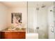 Modern bathroom with glass shower, granite countertops, and decorative cherry blossom arrangement at 1133 14Th St # 3420, Denver, CO 80202