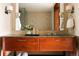 Bathroom vanity with wood cabinets, granite countertop, modern fixtures, and mosaic tile at 1133 14Th St # 3420, Denver, CO 80202