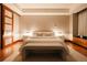 Warm bedroom with hardwood floors, ambient lamps, and a view to bathroom sliding doors at 1133 14Th St # 3420, Denver, CO 80202