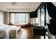 Serene bedroom with a window seat, city views, and minimalist decor at 1133 14Th St # 3420, Denver, CO 80202