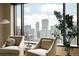 Cozy living room with armchairs and panoramic city views at 1133 14Th St # 3420, Denver, CO 80202