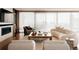 Bright living room showcasing a fireplace, comfortable seating, and expansive windows with city views at 1133 14Th St # 3420, Denver, CO 80202