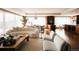 Spacious living room with hardwood floors, modern furniture, a city view, and a decorative chandelier at 1133 14Th St # 3420, Denver, CO 80202