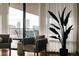 Comfortable sitting area with a view from the balcony and a large plant at 1133 14Th St # 3420, Denver, CO 80202