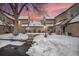Townhome backyard covered in snow during twilight featuring a mature tree in the foreground, with a colorful sunset sky at 2141 S Victor St # B, Aurora, CO 80014