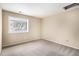 Bedroom featuring a neutral color palette and a large window at 2141 S Victor St # B, Aurora, CO 80014