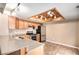 Bright kitchen features stainless steel appliances, ample cabinet space, countertop seating, and a custom wood ceiling feature at 2141 S Victor St # B, Aurora, CO 80014