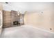 Spacious living room features a stone fireplace, built-in shelving, and a large window at 2141 S Victor St # B, Aurora, CO 80014