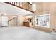 Open-concept living room with high ceilings and a view into the kitchen at 2141 S Victor St # B, Aurora, CO 80014