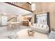 Bright living room featuring hardwood floors, vaulted ceilings, modern furnishings, and a view into the kitchen at 2141 S Victor St # B, Aurora, CO 80014