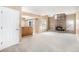 Open-concept living room with fireplace, built-in shelving, and a doorway to the exterior at 2141 S Victor St # B, Aurora, CO 80014