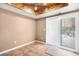 Cozy room with tiled flooring and a sliding glass door leading to the outside, complemented by a unique beamed ceiling at 2141 S Victor St # B, Aurora, CO 80014