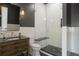 Modern bathroom featuring a glass shower and a wood vanity at 8758 Witez Ct, Parker, CO 80134