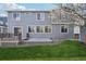 Backyard featuring a deck, gravel area, grass area and patio door at 12248 Kittredge St, Commerce City, CO 80603
