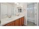 Bathroom featuring a double vanity with wood cabinets and a shower-tub combination at 12248 Kittredge St, Commerce City, CO 80603