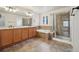 A large bathroom featuring a double vanity, soaking tub and glass enclosed shower at 12248 Kittredge St, Commerce City, CO 80603