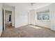 Carpeted bedroom with closet and window view of home next door at 12248 Kittredge St, Commerce City, CO 80603