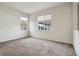 Cozy bedroom with neutral carpet and windows providing natural light at 12248 Kittredge St, Commerce City, CO 80603