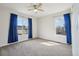 Bright bedroom with a ceiling fan and two windows offering plenty of natural light at 12248 Kittredge St, Commerce City, CO 80603