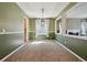 The dining room with a modern light fixture, neutral carpet and adjacent living room at 12248 Kittredge St, Commerce City, CO 80603