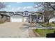 Charming home with a three-car garage, inviting front porch, and well-manicured lawn at 12248 Kittredge St, Commerce City, CO 80603