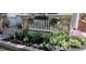 Manicured garden bed with vibrant flowers and lush greenery adds charm to the home's entrance at 12248 Kittredge St, Commerce City, CO 80603