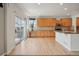 Open kitchen with stainless steel appliances, a center island with a sink, and a sliding glass door to the deck at 12248 Kittredge St, Commerce City, CO 80603