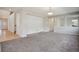 Open-concept living space with neutral walls and plush carpeting at 12248 Kittredge St, Commerce City, CO 80603