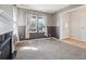 Inviting living room featuring neutral paint, carpet floors, natural light, and a charming fireplace at 12248 Kittredge St, Commerce City, CO 80603