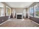 Inviting living room featuring a cozy fireplace and large windows for ample natural light at 12248 Kittredge St, Commerce City, CO 80603