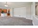 View of the open-concept living room with a peek into the adjacent kitchen at 12248 Kittredge St, Commerce City, CO 80603