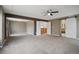 Large bedroom with tan carpet with entrances to ensuite bathroom, landing, and another bedroom at 12248 Kittredge St, Commerce City, CO 80603