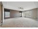 A spacious main bedroom featuring a tray ceiling, fan, and large windows providing plenty of natural light at 12248 Kittredge St, Commerce City, CO 80603