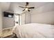 Light bedroom with wood floors and a TV, for cozy relaxation and entertainment at 14742 E Radcliff Pl, Aurora, CO 80015