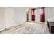 Minimalist bedroom with wood floors, and a floor lamp, offering a serene and uncluttered space at 14742 E Radcliff Pl, Aurora, CO 80015