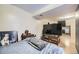 Bedroom features a TV, a bed with a blanket and wooden furniture at 14742 E Radcliff Pl, Aurora, CO 80015