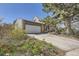 A beautiful exterior view highlighting the home's architecture and spacious driveway, surrounded by colorful foliage at 14742 E Radcliff Pl, Aurora, CO 80015