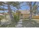 Charming brick home featuring a well-manicured lawn and mature trees enhancing its curb appeal at 14742 E Radcliff Pl, Aurora, CO 80015