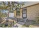 Inviting home exterior with a well-maintained front yard, showcasing a brick facade and an attached garage at 14742 E Radcliff Pl, Aurora, CO 80015