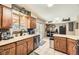 Functional kitchen with wood cabinets, stainless steel appliances, and a sink overlooking the backyard at 14742 E Radcliff Pl, Aurora, CO 80015