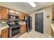 Well-equipped kitchen featuring modern appliances, wooden cabinets, and tile flooring for easy maintenance at 14742 E Radcliff Pl, Aurora, CO 80015