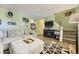 Spacious living area with a large sectional sofa, entertainment center, and stairs leading to the upper level at 14742 E Radcliff Pl, Aurora, CO 80015