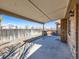 Covered back patio featuring a concrete floor, a seating area, and a fenced-in yard at 1467 S Kenton St, Aurora, CO 80012