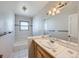 Bathroom with white tiling and a wood vanity with a sink at 1467 S Kenton St, Aurora, CO 80012